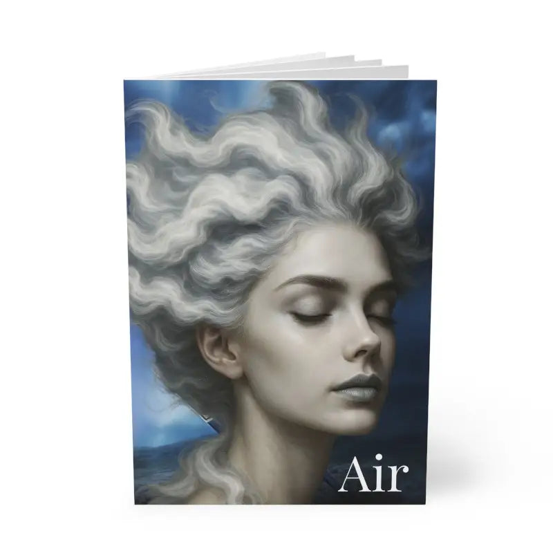 Notizbuch mit Cover zeigt eine ruhige Frau mit wolkigem Haar und dem Wort Luft